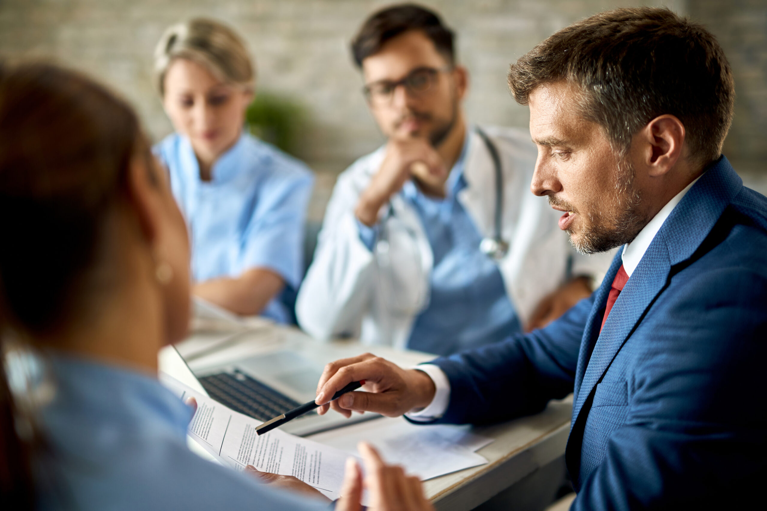 Healthcare arbitration in India — professionals reviewing a hospital commercial agreement